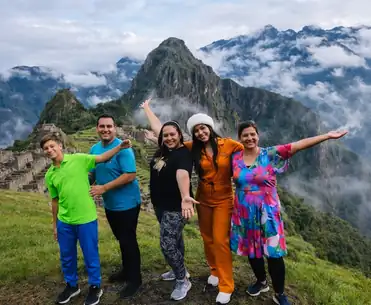 Happy family enjoying a guided tour at the Machu Picchu citadel in Peru | Inca Culture Travel