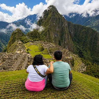 Couple sitting and enjoying the panoramic view of Machu Picchu during the Short Inca Trail in Peru | Inca Culture Travel