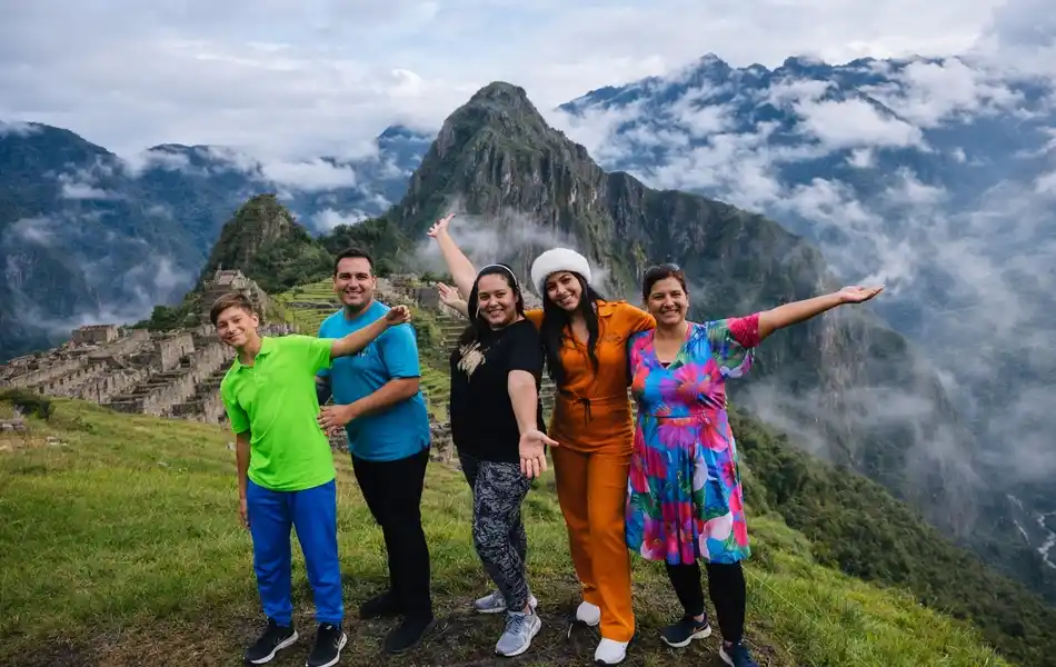 Happy family posing together at the classic Huayna Picchu mountain viewpoint | Inca Culture Travel
