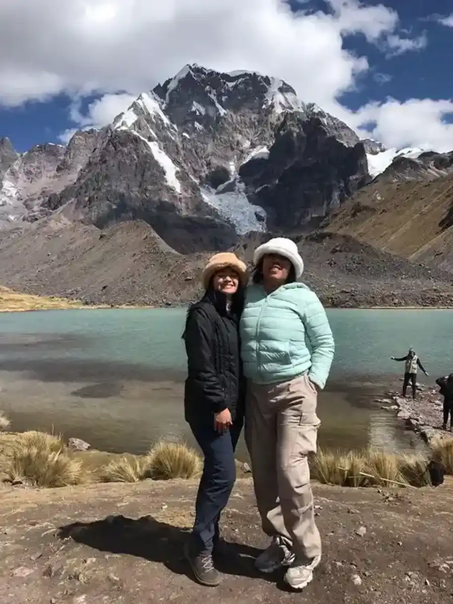 Couple enjoying the scenery of Humantay Lagoon and the snow-capped peaks of the Andes | Inca Culture Travel