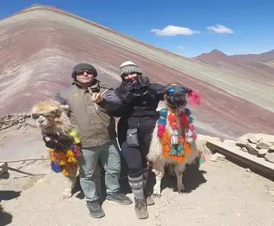 Couple enjoying the panoramic view of Rainbow Mountain with colored slopes | Inca Culture Travel 