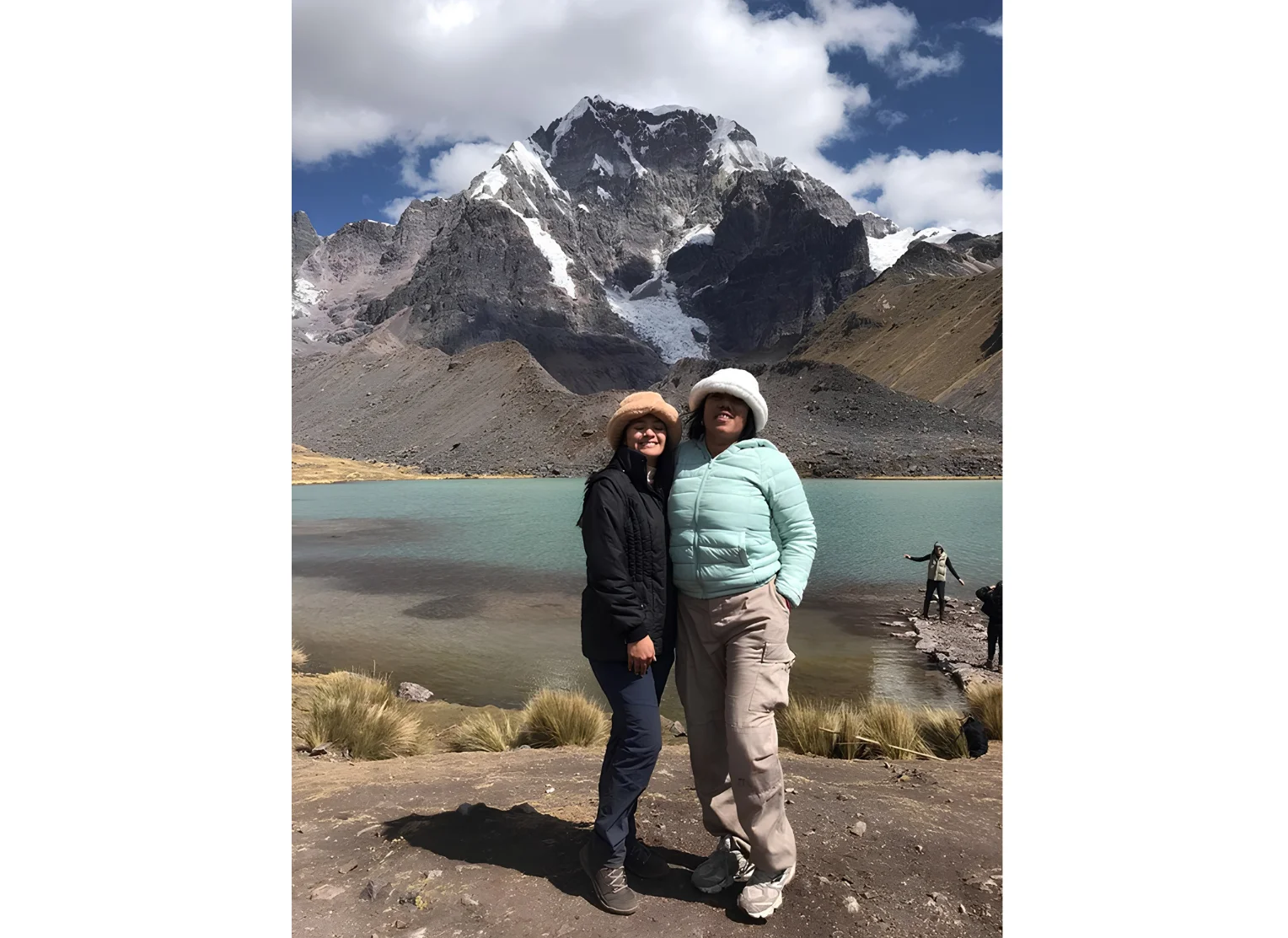 Couple enjoying the view of Humantay Lake and the surrounding snow-capped Andes