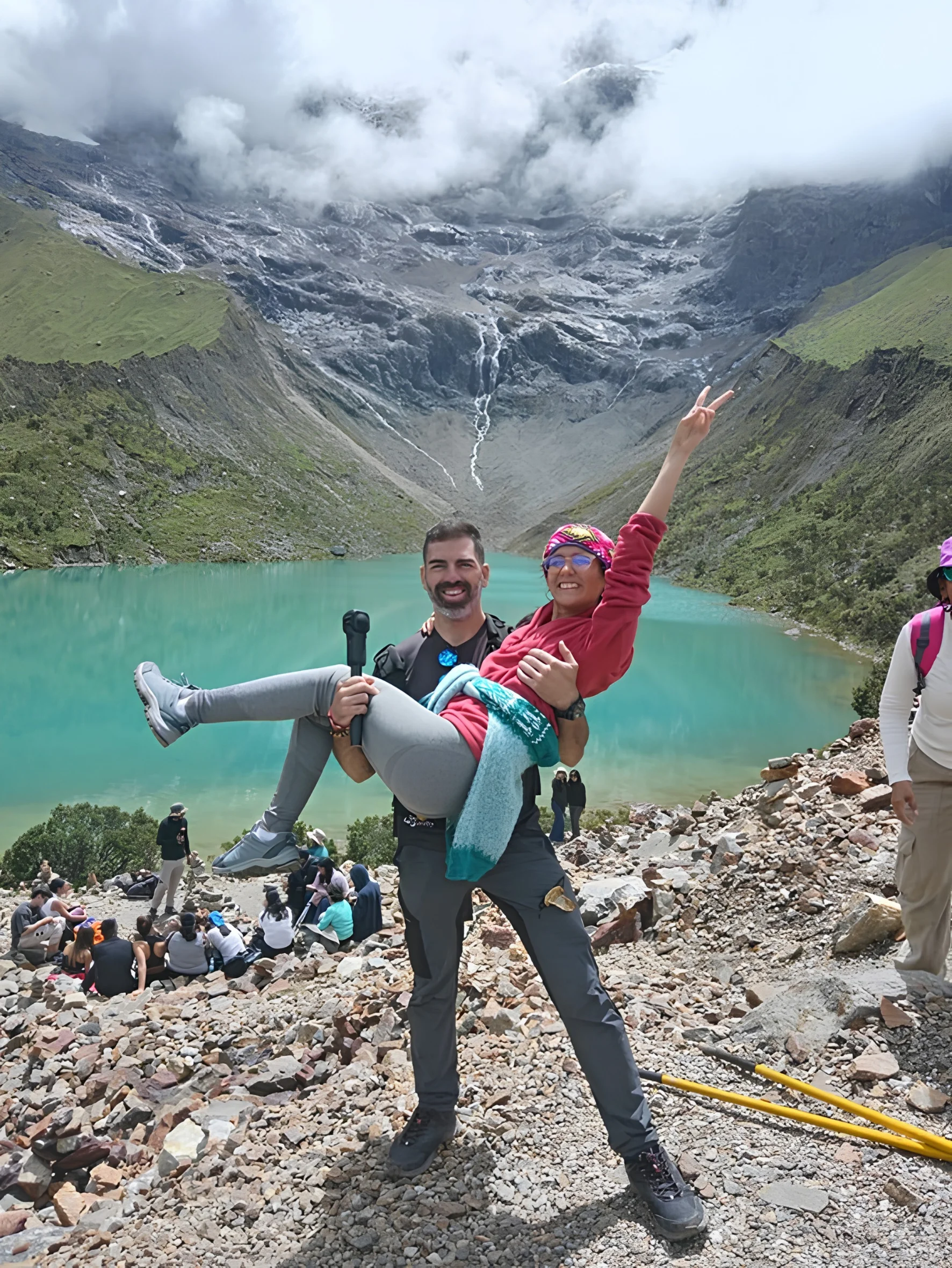 A couple of hikers walking along the Humantay Lagoon trail with panoramic views of the Andes | Inca Culture Travel