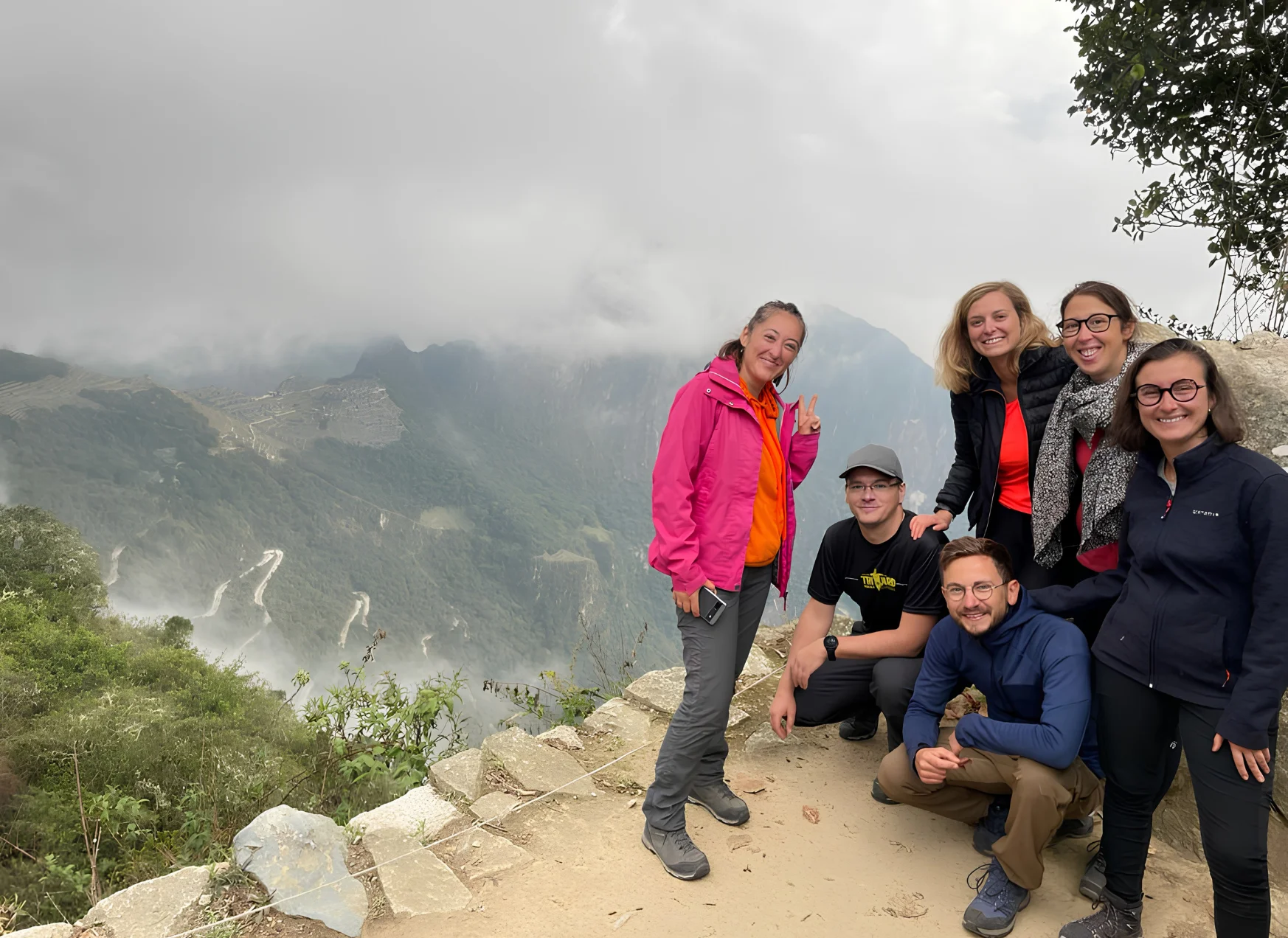 Group of travelers at the Inca Trail entrance sign on the route to Machu Picchu