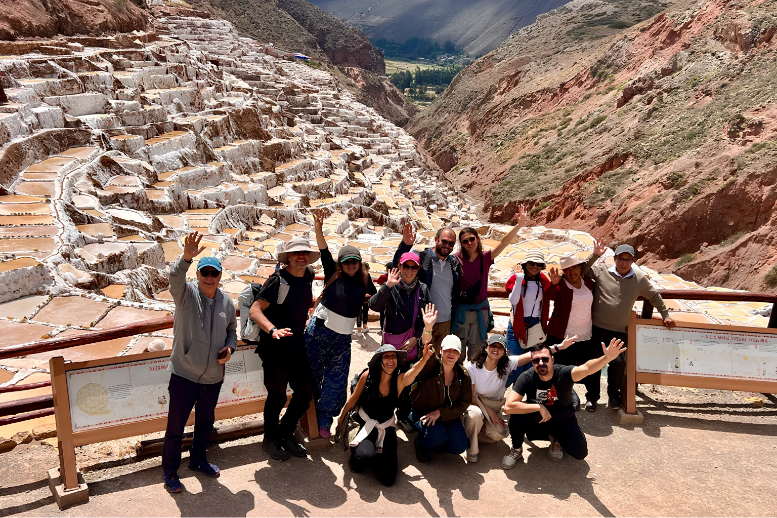 Tour group overlooking the terraced salt ponds of the Maras Salt Mines in the Sacred Valley of Peru.