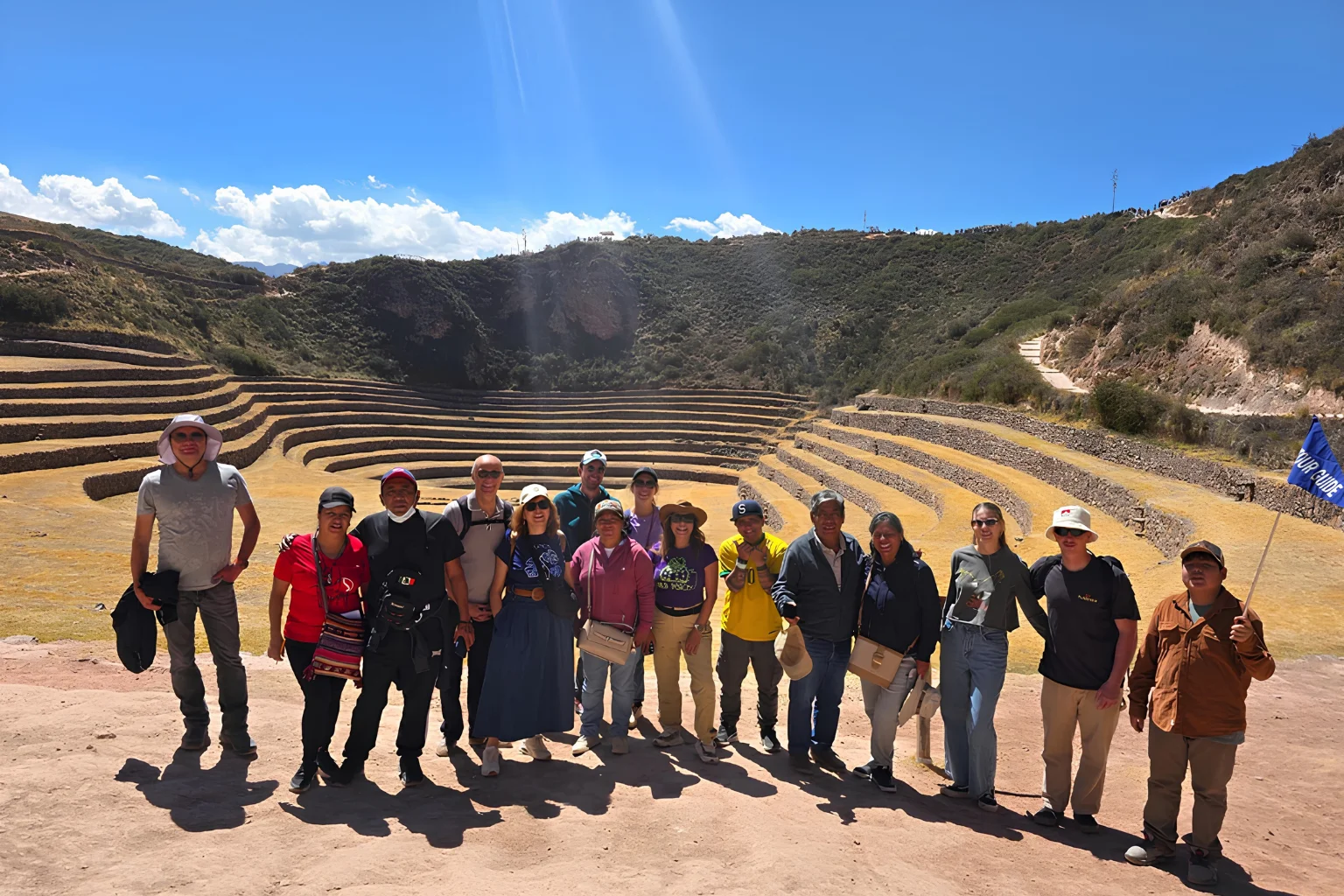 Travelers in front of the circular Inca terraces at Moray during a Super Sacred Valley Tour from Cusco.
