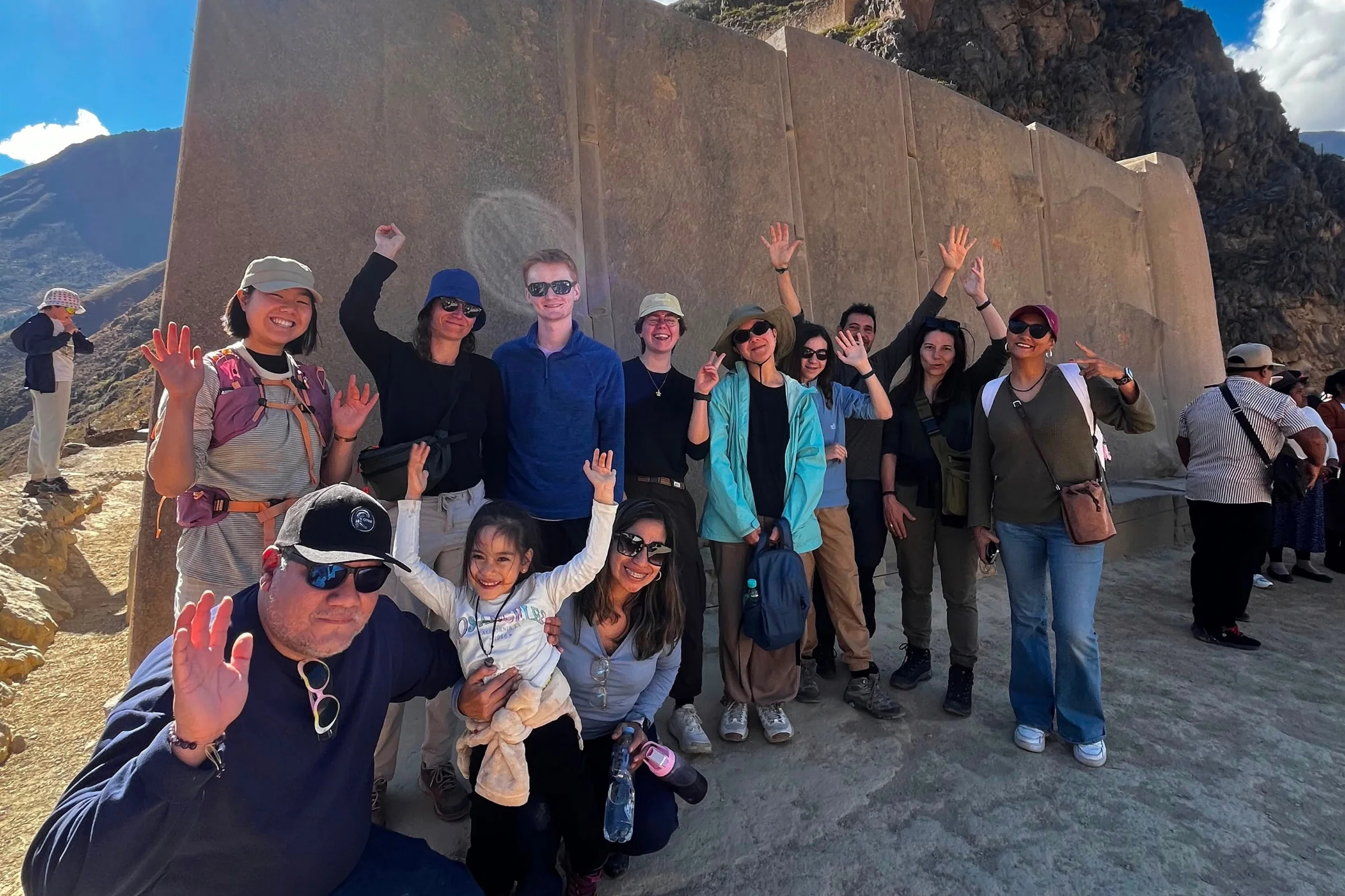 Tour group visiting the monumental Inca stone walls at Ollantaytambo during a Super Sacred Valley Tour from Cusco.
