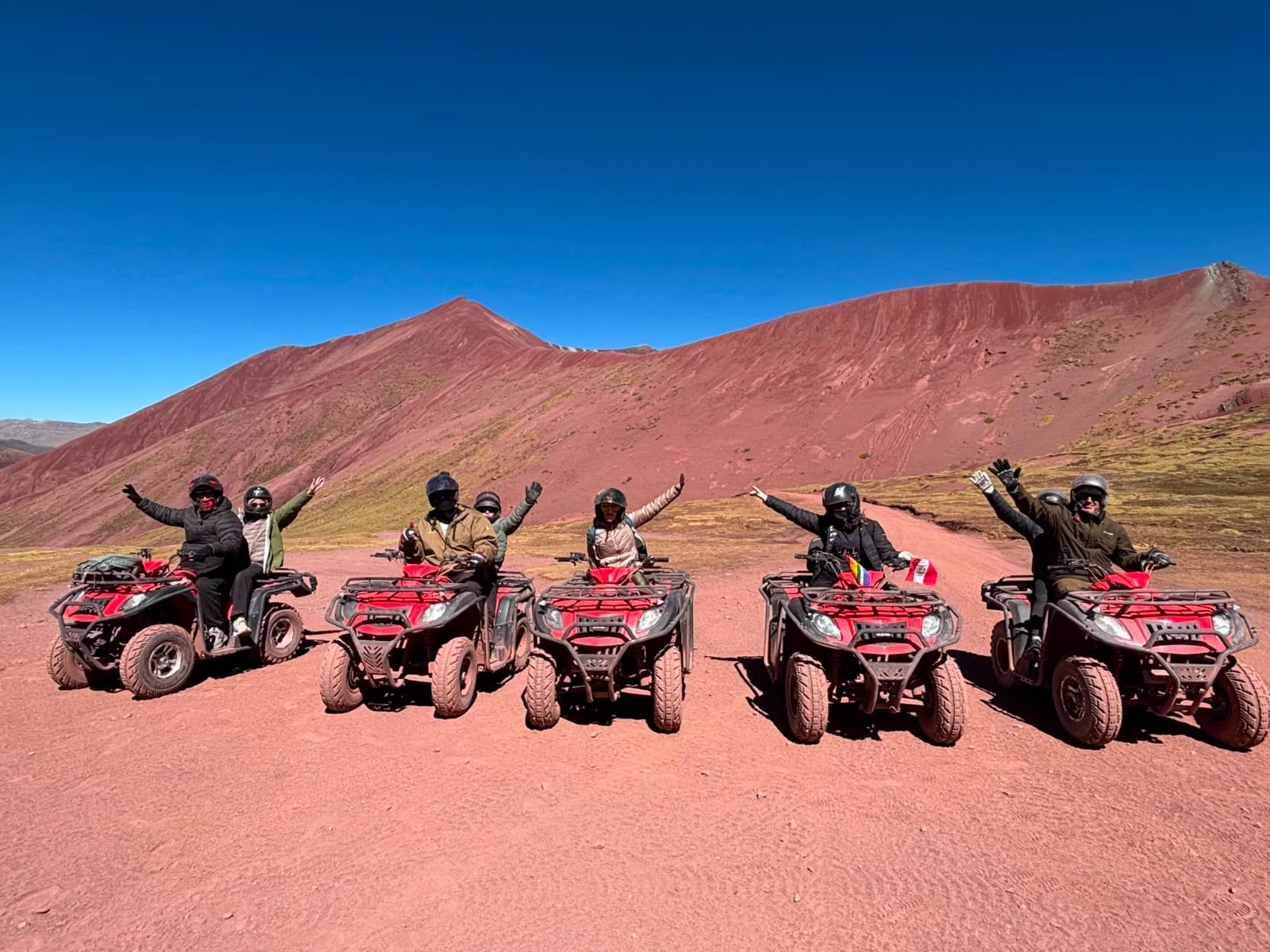 Travelers riding quad bikes during the Rainbow Mountain tour from Cusco