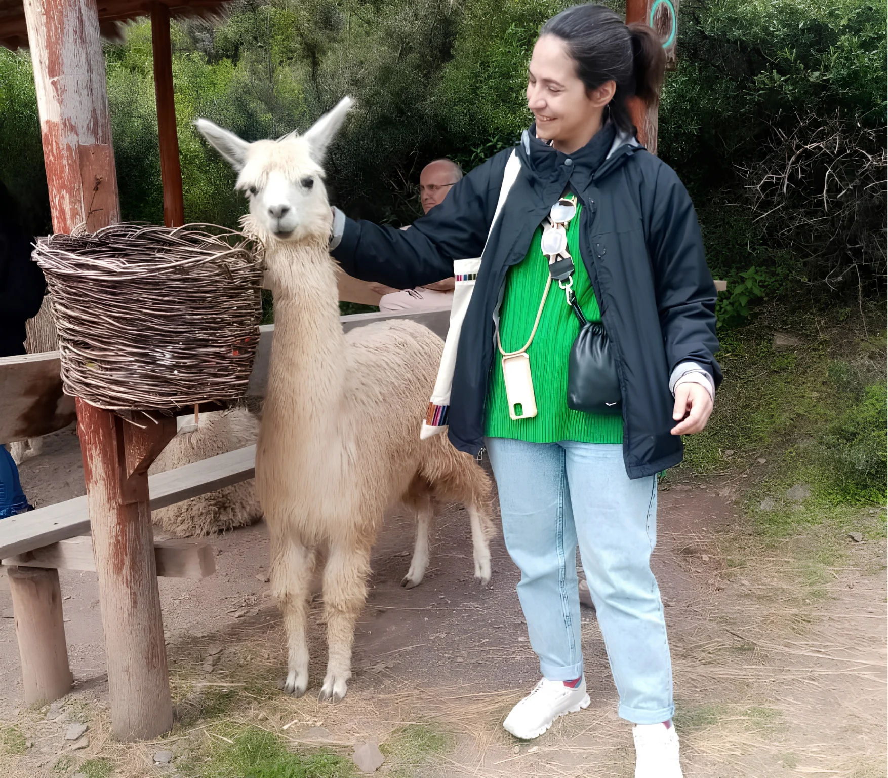 Traveler posing with an alpaca at a local cultural stop during a Super Sacred Valley Tour near Cusco.