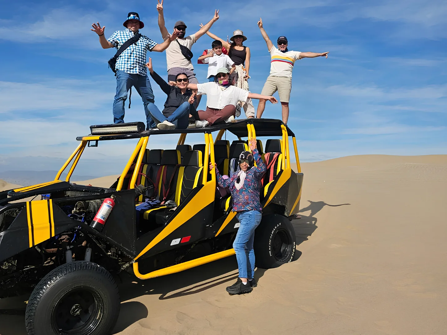 Travelers enjoying a dune buggy experience in the Huacachina desert.
