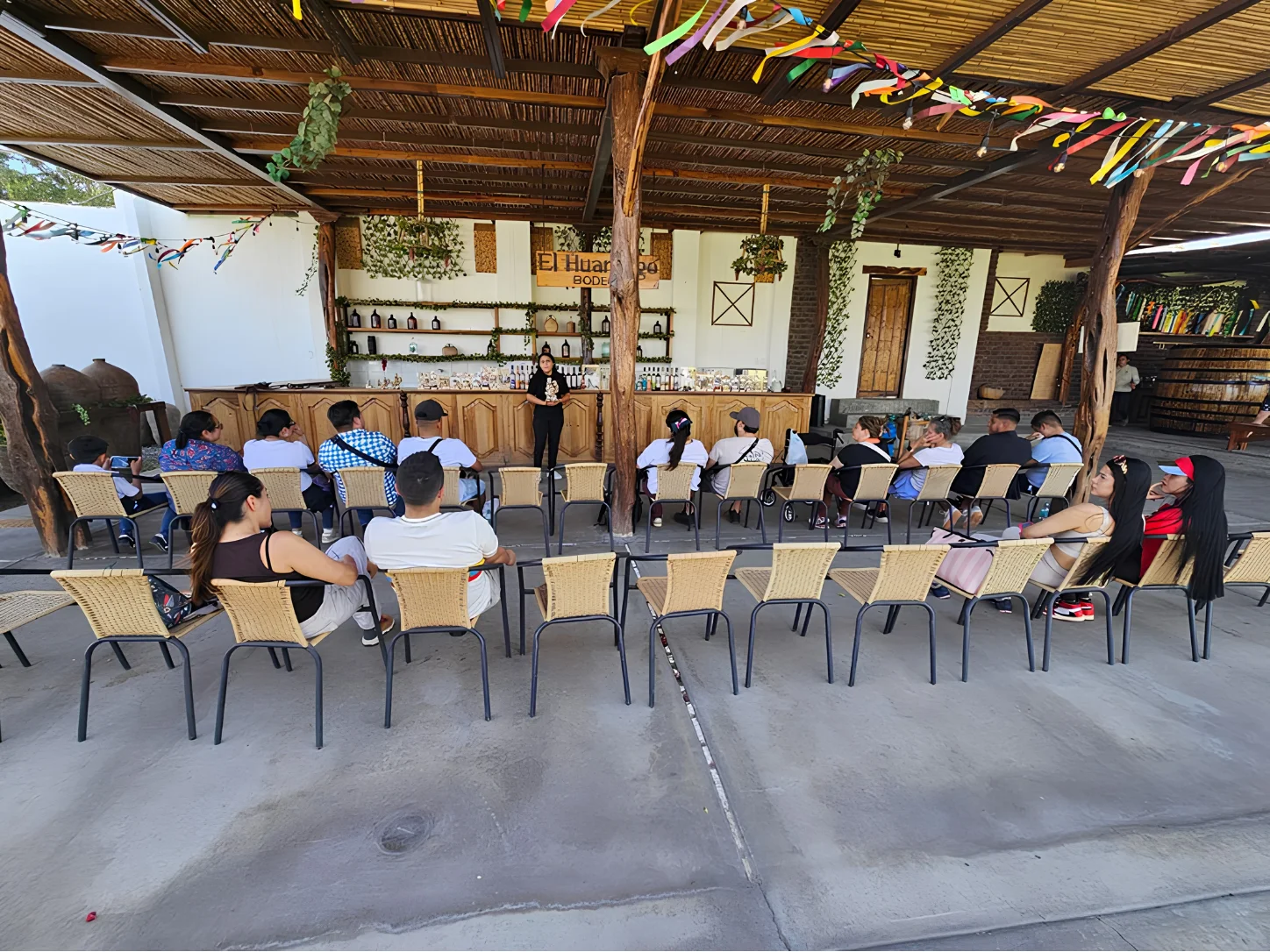 Travelers learning about local wine and pisco during a winery visit in Ica.
