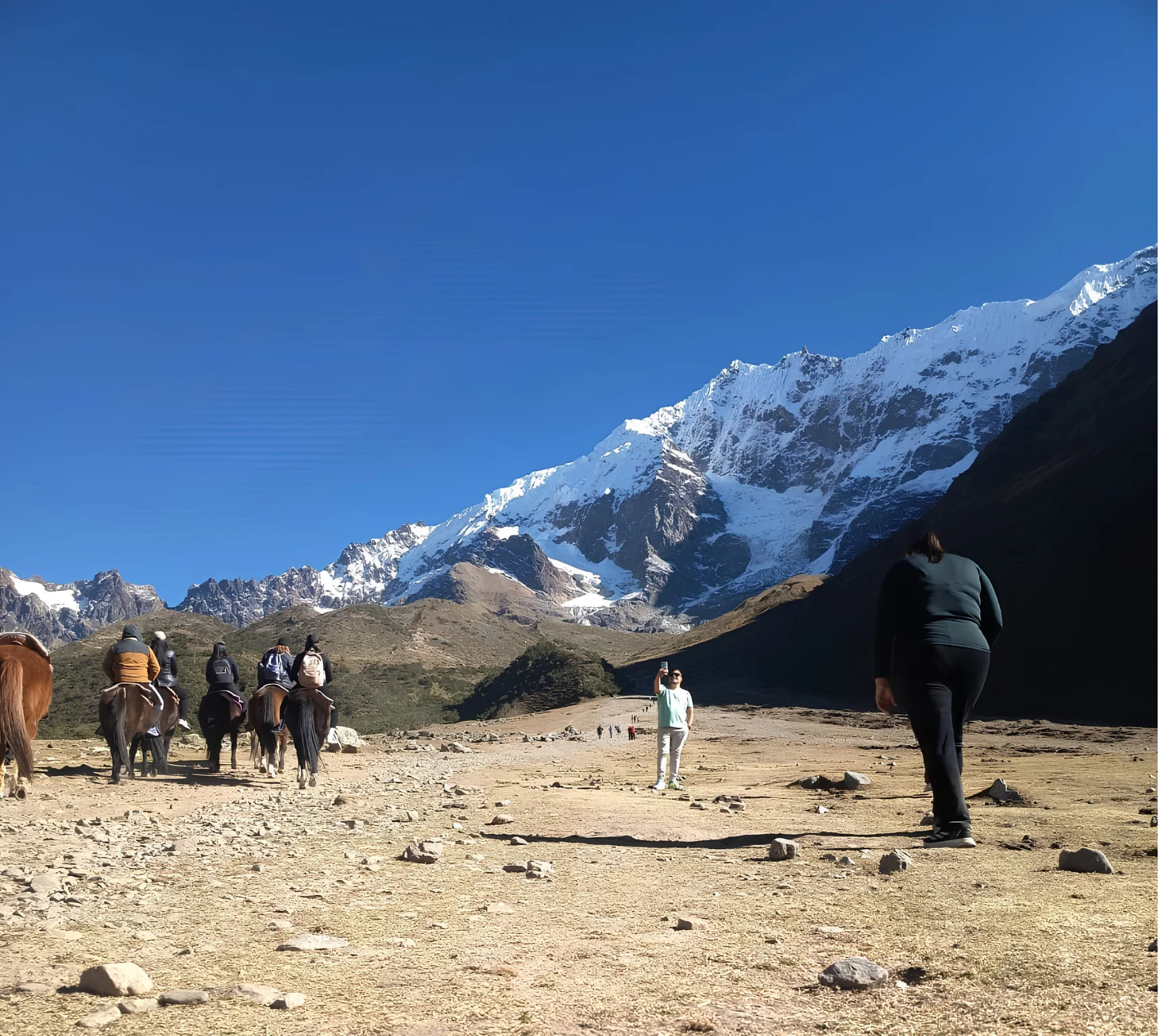 Hikers and pack horses crossing the high Andes during the Salkantay Trek 4 Days.