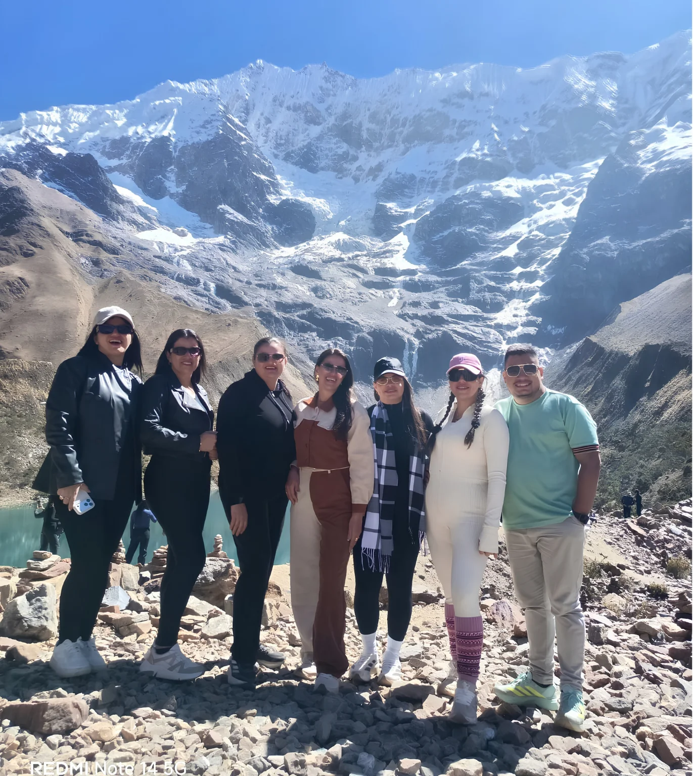 Group of travelers beneath snow-covered mountains during the Salkantay Trek 5 Days.
