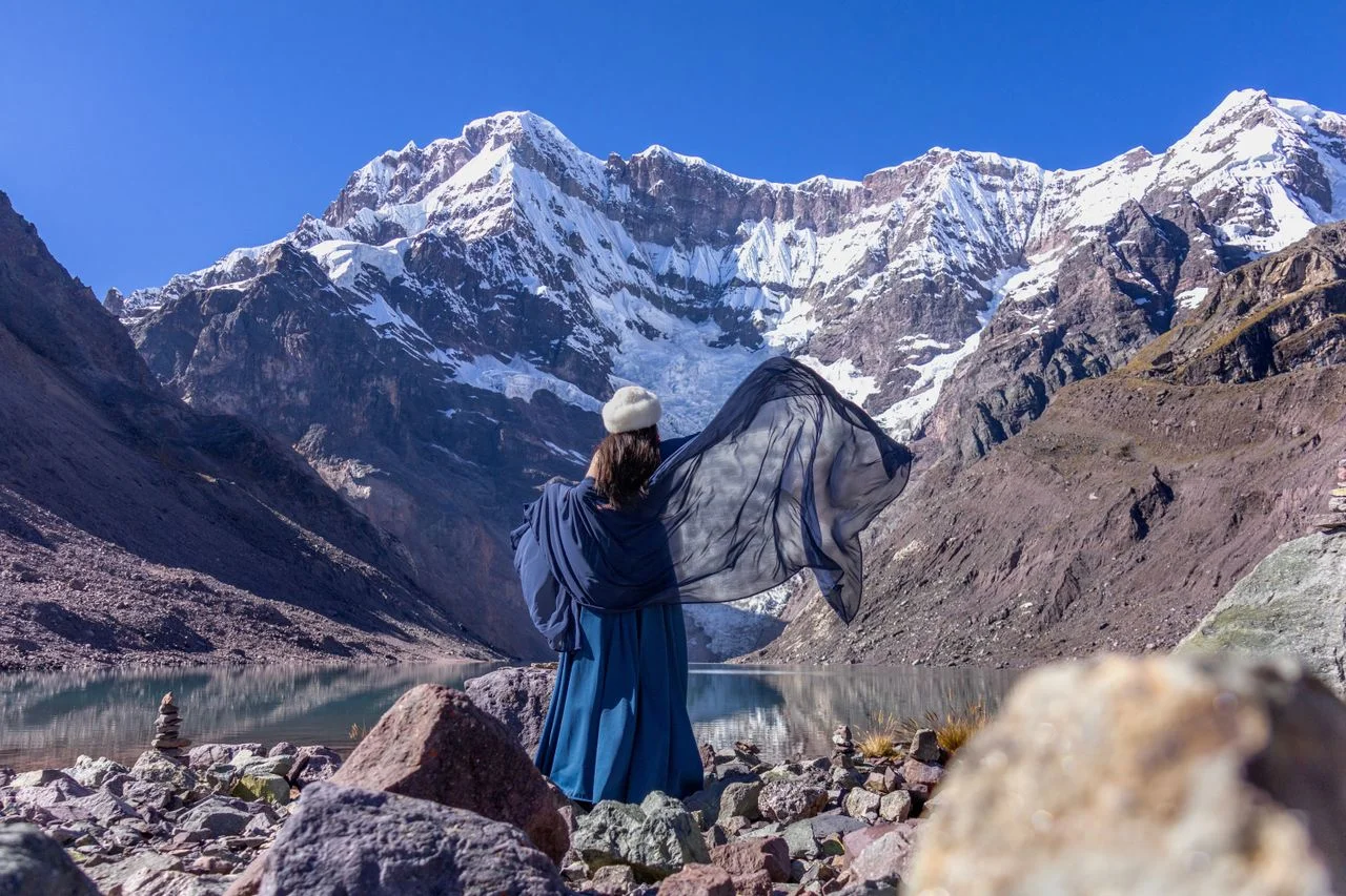 Traveler overlooking Humantay Lake and snow-covered mountains during the Salkantay Trek 5 Days to Machu Picchu.
