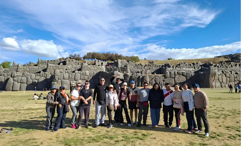 Tour group standing on the archaeological grounds at Sacsayhuaman during a Cusco City Tour.