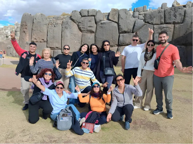 Travelers on the Cusco City Tour in front of the massive Inca stone walls at Sacsayhuaman.
