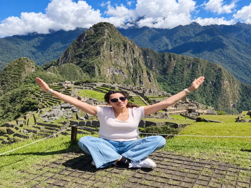 Woman overlooking Huayna Picchu and the Machu Picchu citadel