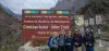 Tourists at the entrance to the Inca Trail to Machu Picchu, next to the official Inca Trail sign in the Peruvian Andes